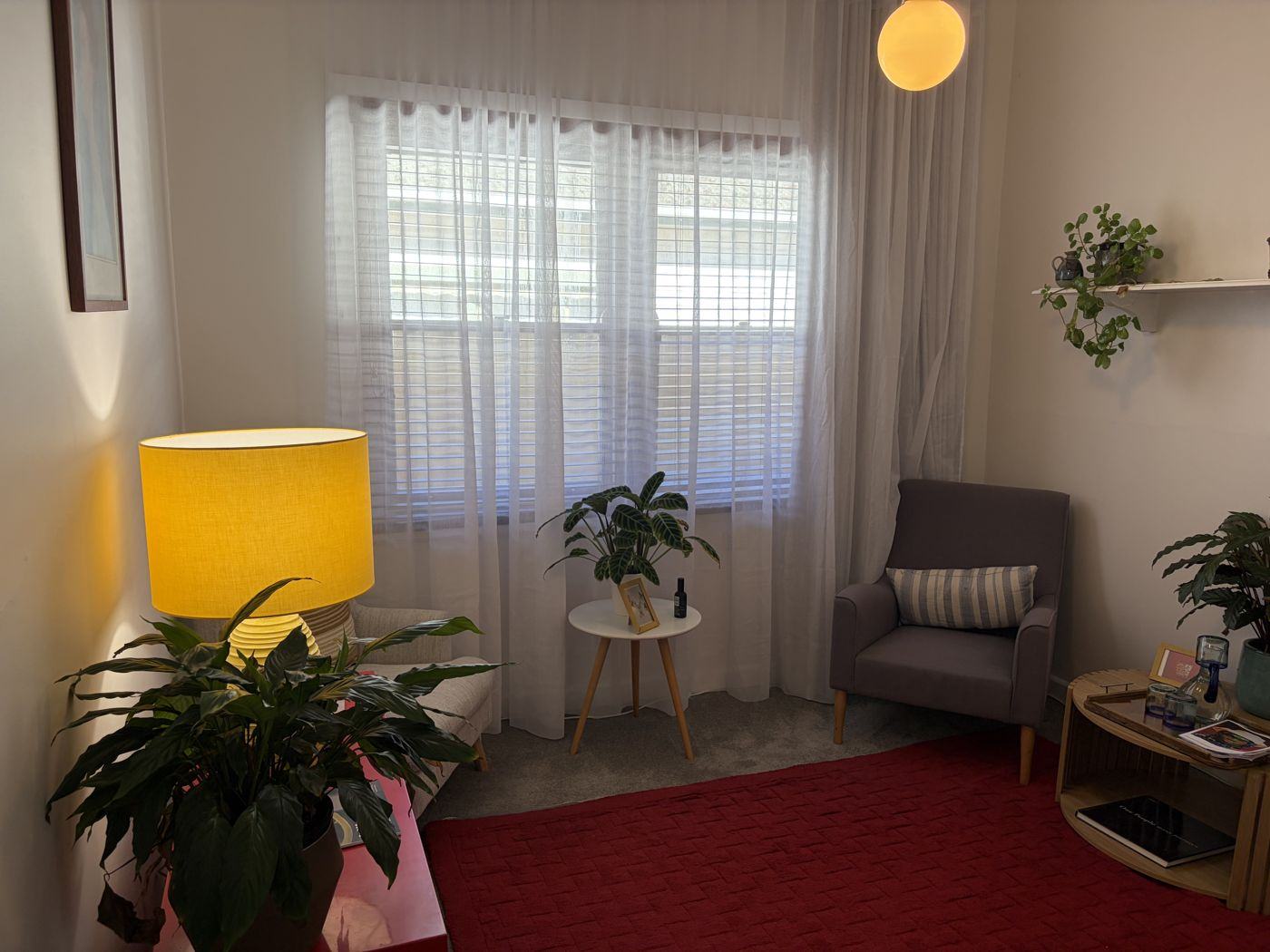The waiting room, with armchairs, plants and a reading lamp